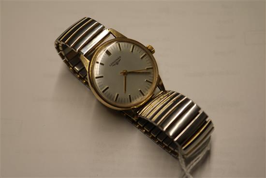 A gentlemans 9ct gold Longines manual wind wrist watch.
